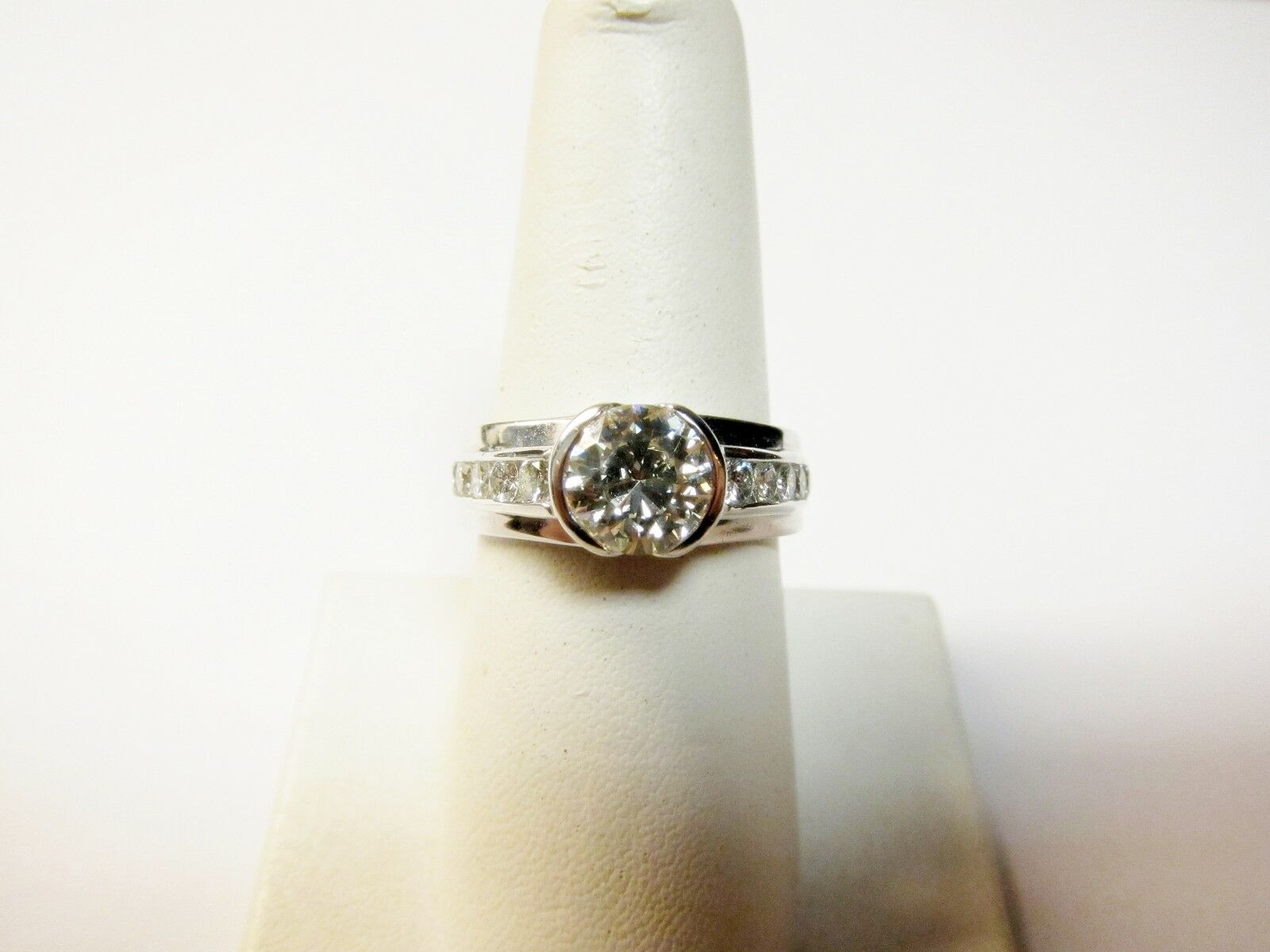 CERTIFIED ROUND BRILLIANT HALF BEZEL SET DIAMOND SIDE CHANNEL ENGAGEMENT RING